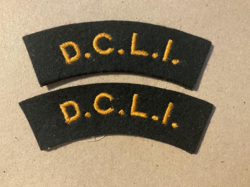 Post war D.C.L.I gold on dark green shoulder titles