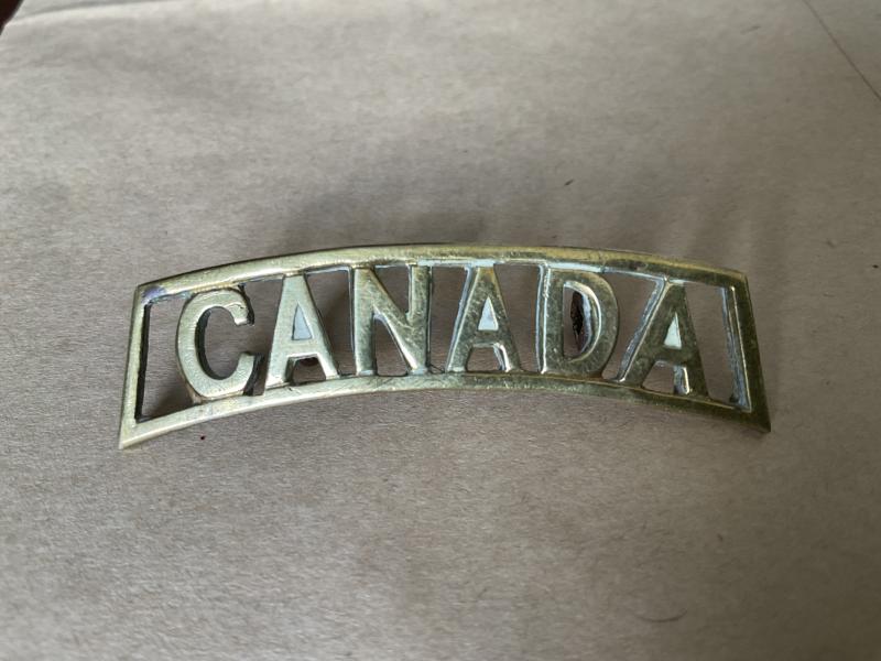 WW1 CANADA brass shoulder title , voided example
